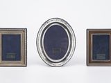 three different sized picture frames sitting next to each other on a white surface