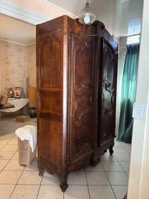 a large wooden cabinet in the middle of a room