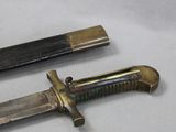 two different types of knives on a white surface