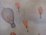 painting of a group of hot air balloons flying in the sky