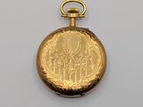 an image of a gold pocket watch on a white surface