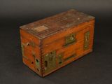 a small wooden box with a metal latch on it
