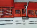 a lot of silverware in a red case on a table