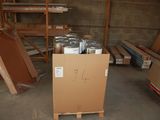 a cardboard box with cans of paint on it in a warehouse