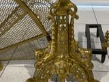 a gold umbrella and a gold fan on a tile floor