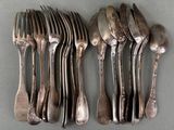 a lot of silver spoons and forks on the table