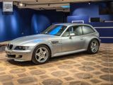 a silver car that is on display in a showroom