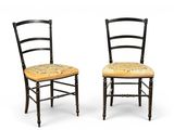 pair of black painted chairs with floral upholstered seat cushions
