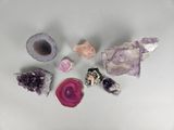 several different types of crystals are arranged on a white surface