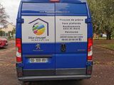 a blue van that is parked in a parking lot