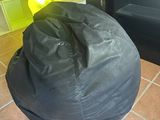 a bean bag sitting on the floor in front of an oven