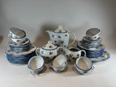 a lot of blue and white dishes and cups on the table