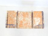 three old books stacked on top of each other on a table