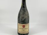 a bottle of wine sitting on top of a white table