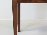 a small wooden table with a drawer on top of it