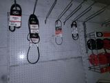 many hooks and hooks hanging on the wall of a store