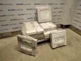a pile of boxes sitting on the floor next to a wall