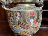 a large ornate vase on a table in a room