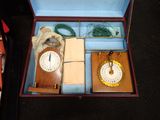 a box with a clock and other items inside of it