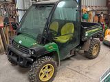 a small green utility vehicle parked in a garage