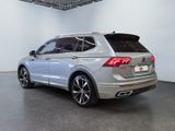 the rear end of a silver volkswagen suv parked in a room