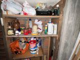 a shelf with many items on it in the corner of a room