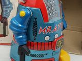 a toy robot that is sitting next to a box