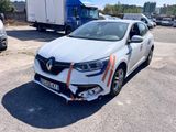a white car with orange stripes parked in a parking lot