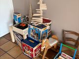 a pile of books sitting on a table next to a chair