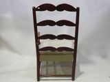 a small wooden chair with a cushion on top of it