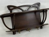 a wooden shelf with a cat design on it