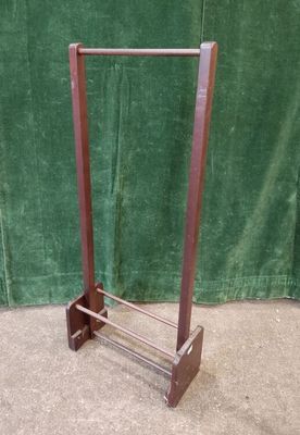 an image of a wooden rack with a green curtain in the background