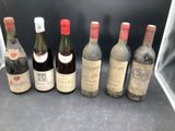 six bottles of wine are lined up in a row on a counter