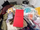 a red book sitting on top of a pile of clothes