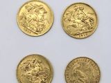four gold sovereigns, one of which is a horse and the other of which is a lion