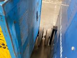 a blue box with a yellow tag on it in a warehouse