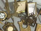 a lot of antique picture frames and pictures on the table