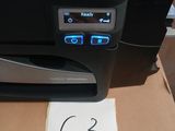 a printer sitting on top of a box with a price tag on it