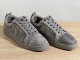 grey sued sneakers with laces on top of a wooden table