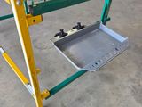 a yellow and green table with a metal tray underneath it