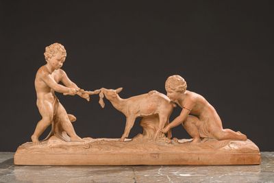 an image of a statue of a boy and a girl feeding a goat