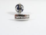 a pair of cufflinks that are sitting on a table