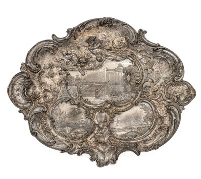 an antique silver plate with a picture of a castle on it