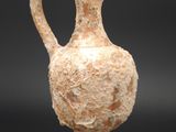 a small vase that is sitting on a glass stand