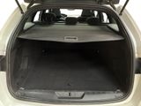 the back of a car with the trunk open and the seats folded down