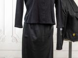 two mannequins in a room with a black dress and a black jacket