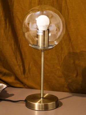 a lamp that is sitting on a table next to a bag