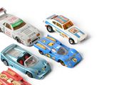 several toy cars are lined up in a row on a white surface