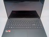 a laptop that is open on a white surface