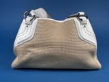 a close up of a white purse on a blue background